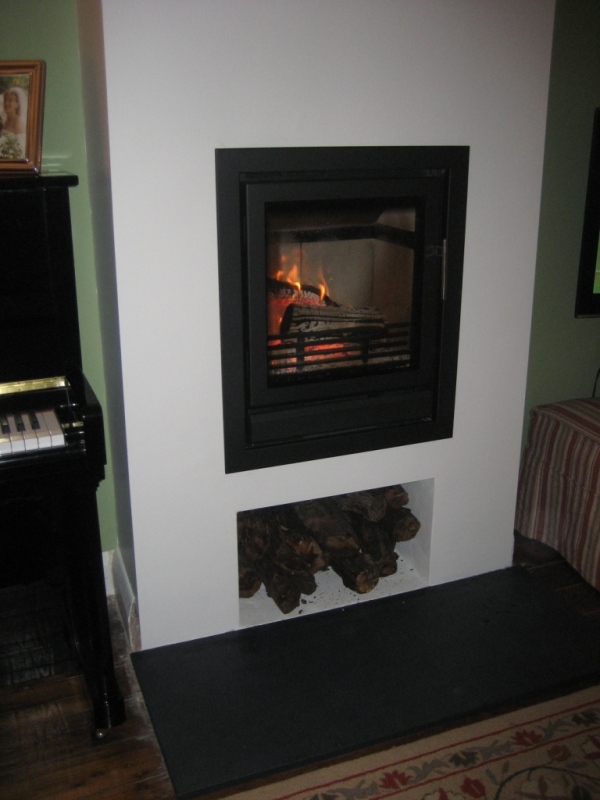 contemporary wood burning stove with log storage shelf