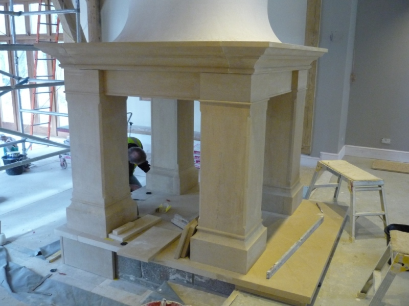 Four sided Bathstone fireplace being fitted