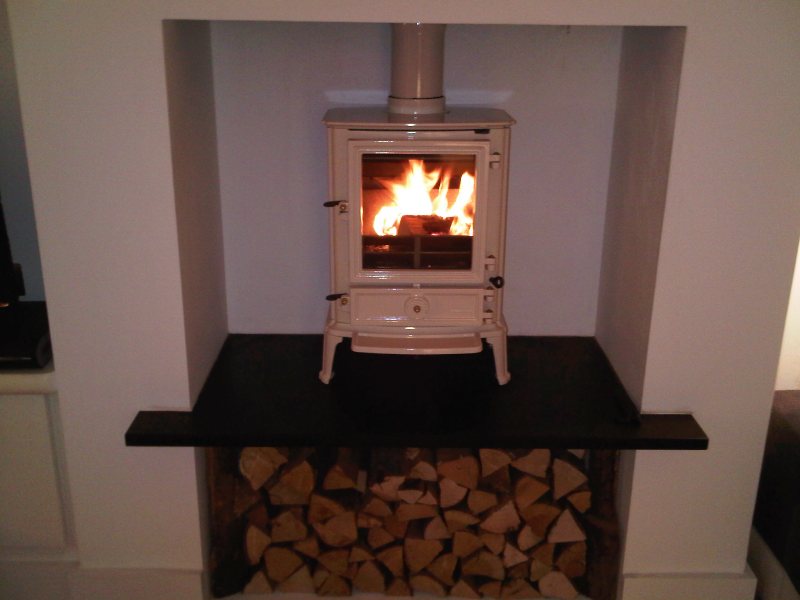 Ivory wood burning stove with log storage beneath