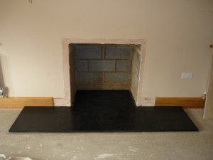 Slate hearth fitted for large fireplace installation in Surrey