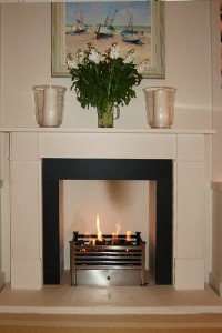 Elegant limestone fireplace with remote control fire