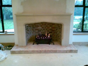 Large Tudor Limestone Fireplace in Guildford complete with basket