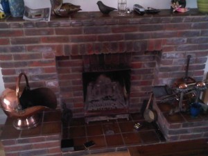 Unfashionable red brick fireplace waiting for replacement