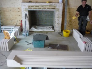 Stone fireplace in Chobham being installed in barn conversion