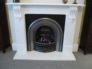 Victorian corbel fireplace with arched cast iron insert