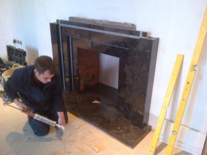 Stunning Granite Fireplace: Landing fireplace being installed