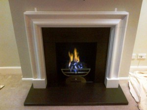 Limestone bolection fireplace with Morris basket