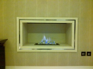 Limestone hole in the wall fireplace with F500 gas fire from Nu Flame with trim