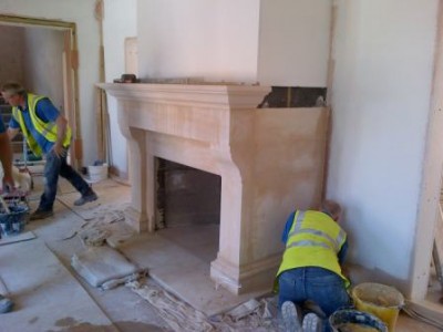 Installing large hallway bathstone fireplace 