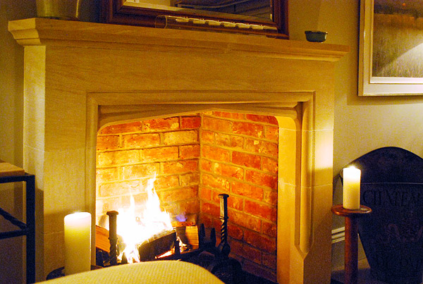 Limestone Tudor traditional fireplace in Surrey