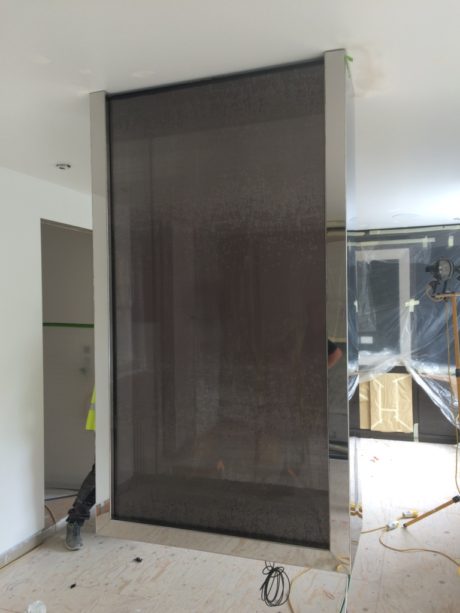 Hanging fireplace in the bedroom with fabric on glass
